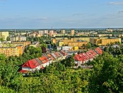 panoramic view of residential buildings among green trees