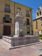 aged water fountain with lion sculpture