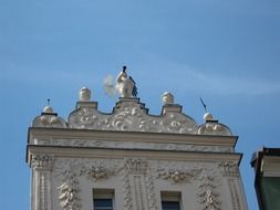 white building with an angel on the roof