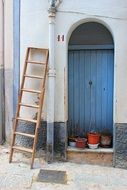 wooden staircase near the blue door