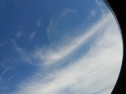 view from the building to the sky with white clouds