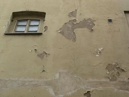 small window on the shabby facade