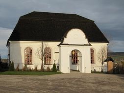 white building with black roof Church in Sweden