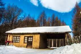 old house near forest at winter, china, jiapigou