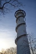 lighthouse with external spiral staircase at evening sky