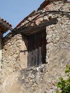 black shutters on the crumbling building in France