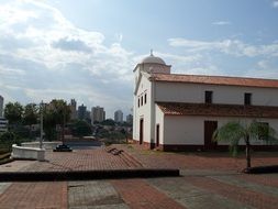 square in front of a christian church on a sunny day