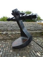 bronze anchor monument on the stones