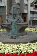 bronze statue of a woman with a load on her head in Tenerife