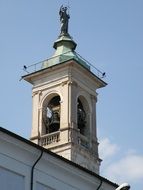 church tower with a sculpture against a clear sky