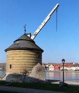 old crane on a river bank