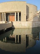 the lake building is reflected in the water