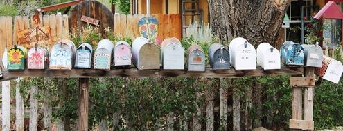 mailboxes on the fence