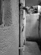 wall of a stone house in black and white image