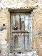Wooden door at the entrance of a old abandoned building