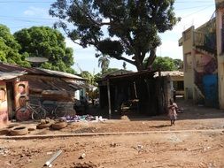 girl on the background of houses in the Gambia
