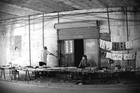 monochrome picture of bazar under the bridge