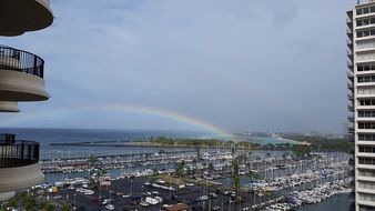 Panorama of the Hawaiian port against the background of the rainbow
