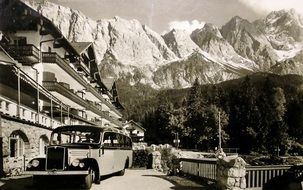 retro postcard with a bus on the background of the Zugspitze mountain