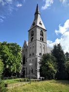 bell tower of the church on a green hill, rollesbroich