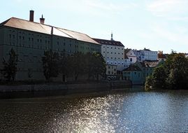 multi-storey houses on bank of calm river at summer
