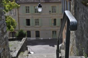 black metal railing at stone stairs in old town