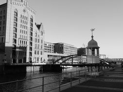 black and white photo of buildings by the river in hamburg