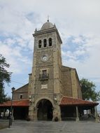 Church tower with the clock in the Asturias