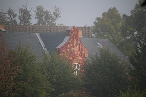 house roof in autumn fog