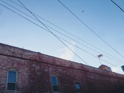 old brick building with american flag