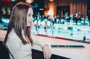 photo of brunette with long hair in a cafe