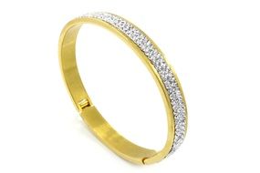 a gold bracelet on a white background