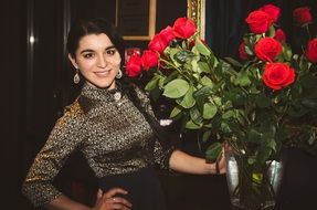 beautiful young girl smiles red flowers