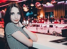 photo of the girl in black and white dress in the bar