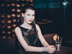 photo of model in an evening dress in the bar