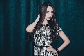 young model is posing on a green background