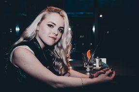 model with long curly blond hair with the drink