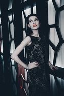 model in long evening dress on a background of doors