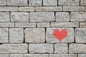 stone wall with red heart