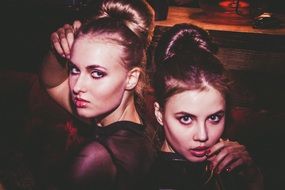 Two models with fashionable hairstyles