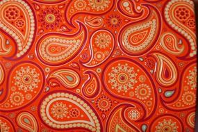 red and yellow paisley ornament