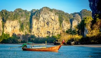 Boat on the rocks background in Thailand