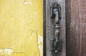 Old door handle on a wooden door