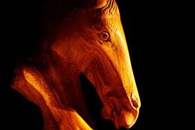 horse statue wood background black