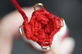 knitting spool with red yarn