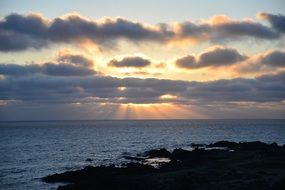 sunset clouds sunbeams see horizon