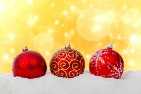 red christmas baubles in snow