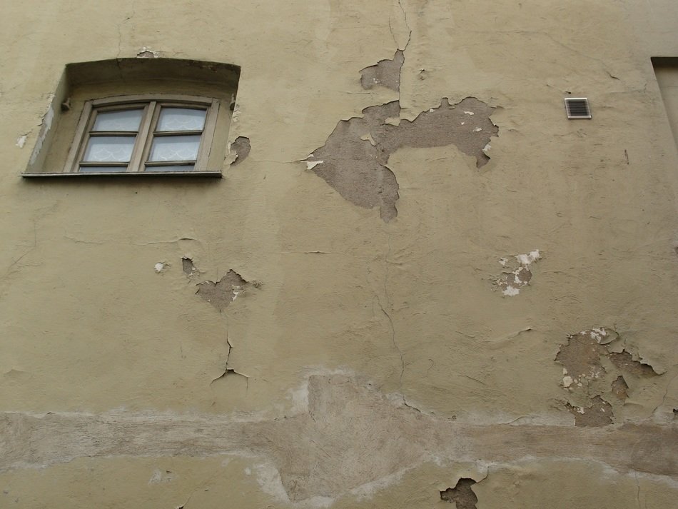 small window on the shabby facade