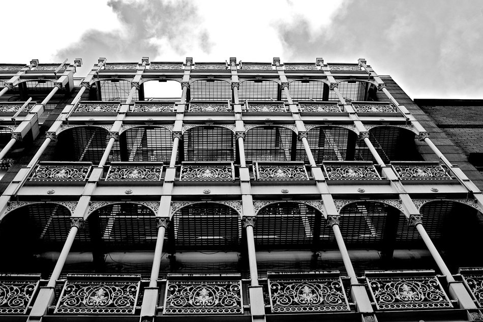 wrough iron passages on facade of old building