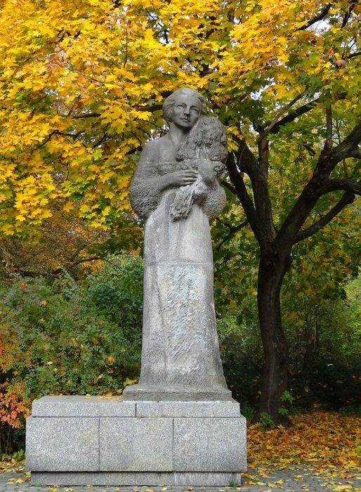 statue of musician Grazyna Bacewicz among colorful nature in Poland